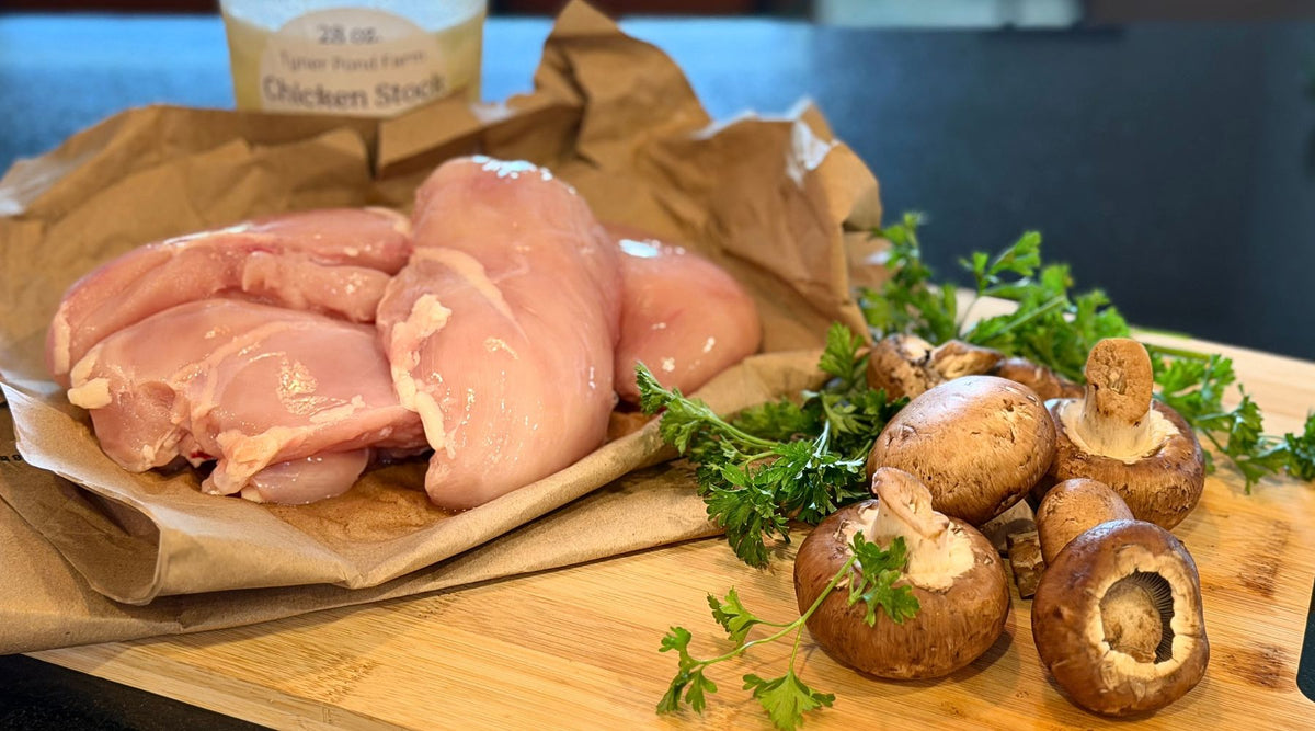 Pasture-raised chicken breasts with mushrooms, fresh herbs, and chicken stock prepared for a special dinner.