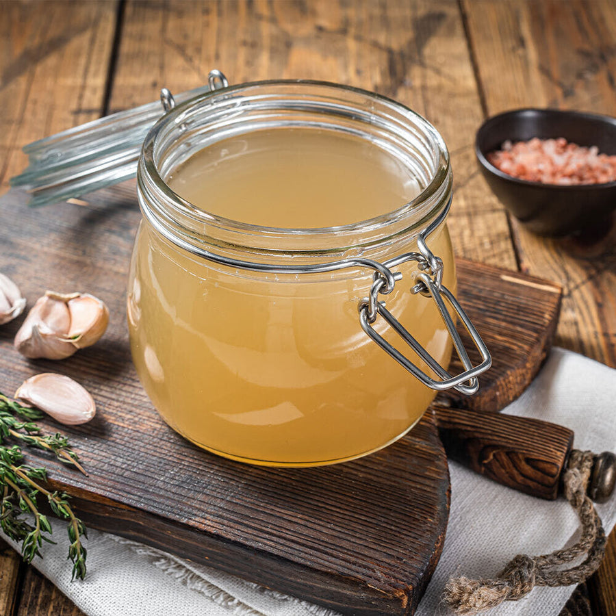 Golden chicken broth made from pasture-raised chickens in a glass jar