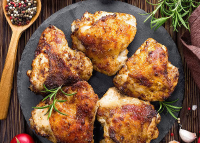 Cooked pasture-raised chicken thighs with crisp skin