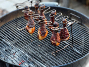 Pasture-raised chicken drumsticks cooking on a smoker
