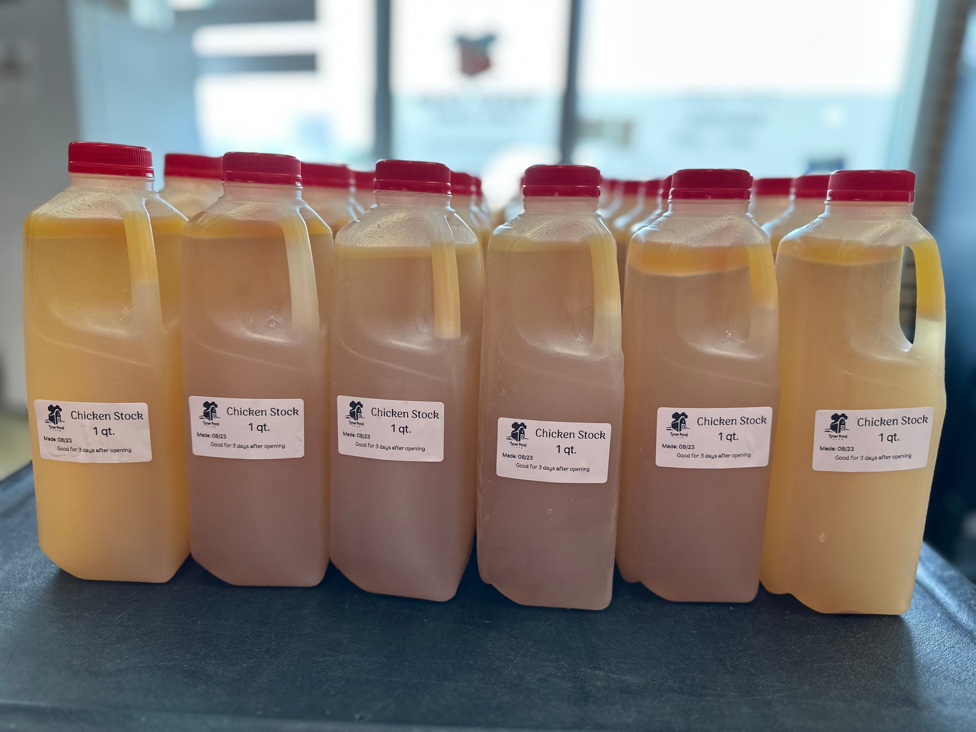 Frozen containers of Tyner Pond Farm chicken broth