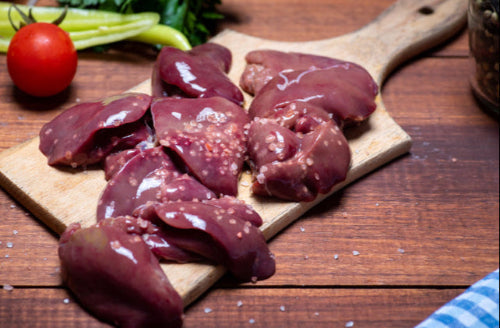 Raw pasture-raised chicken livers on a cutting board