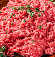 Side view of raw ground round with visible lean texture, made from grassfed beef