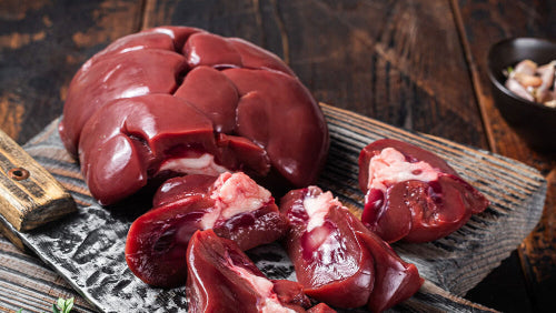 Raw grassfed beef kidney on butcher paper, whole and unprocessed