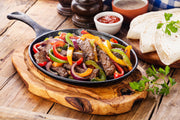 Grilled grassfed skirt steak sliced for fajitas with peppers and onions, pasture-raised at Tyner Pond Farm